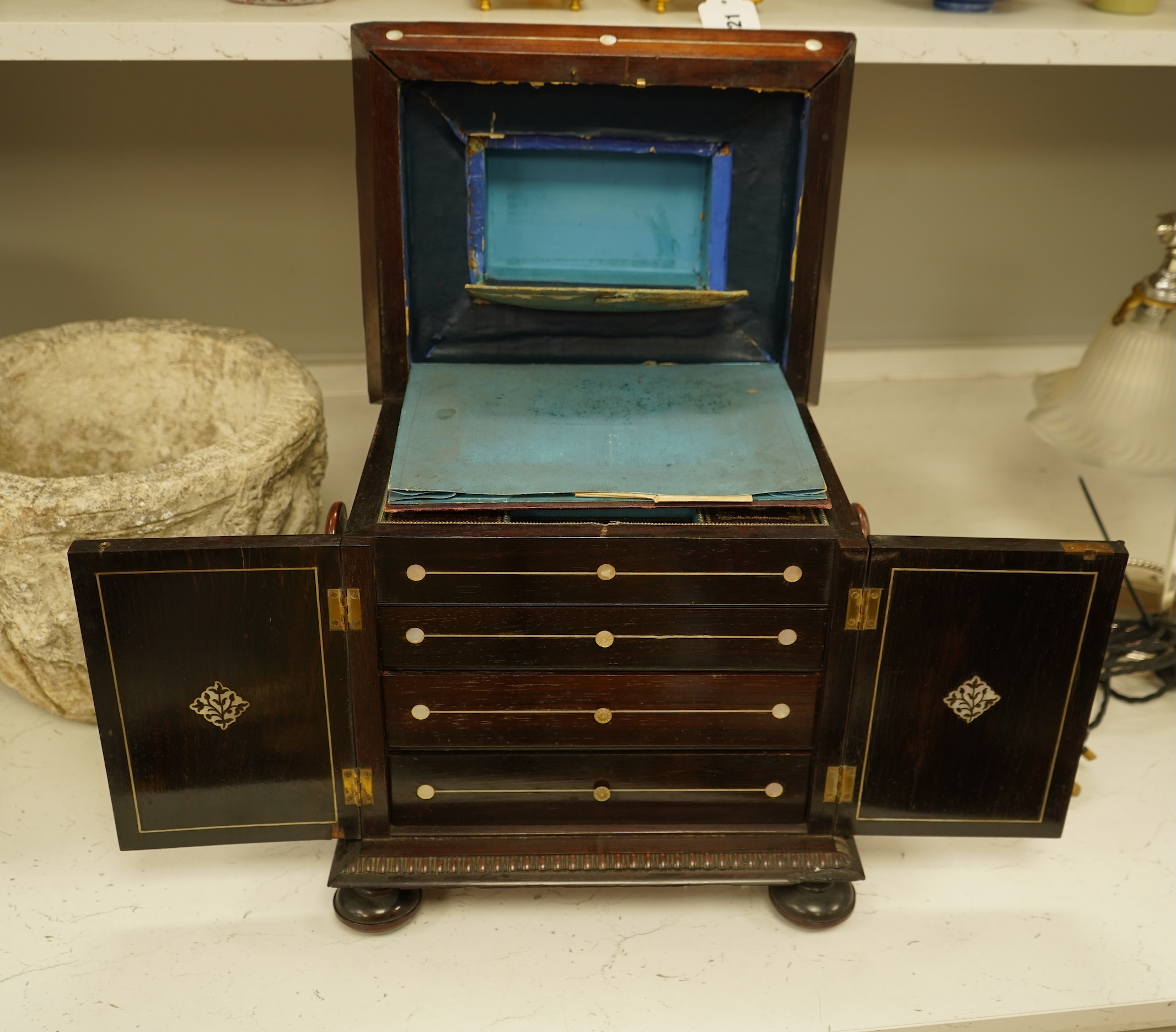 A William IV rosewood and mother of pearl inlaid sewing and writing cabinet with tooled Moroccan leather fitted interior, 37cm high
